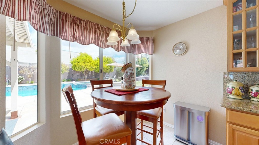 794 Banyonwood Drive Oceanside, CA 92057 - Photo 26 of 62 a dining room with furniture a rug and a chandelier