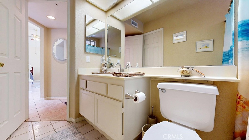 794 Banyonwood Drive Oceanside, CA 92057 - Photo 31 of 62 a bathroom with a granite countertop toilet sink and mirror