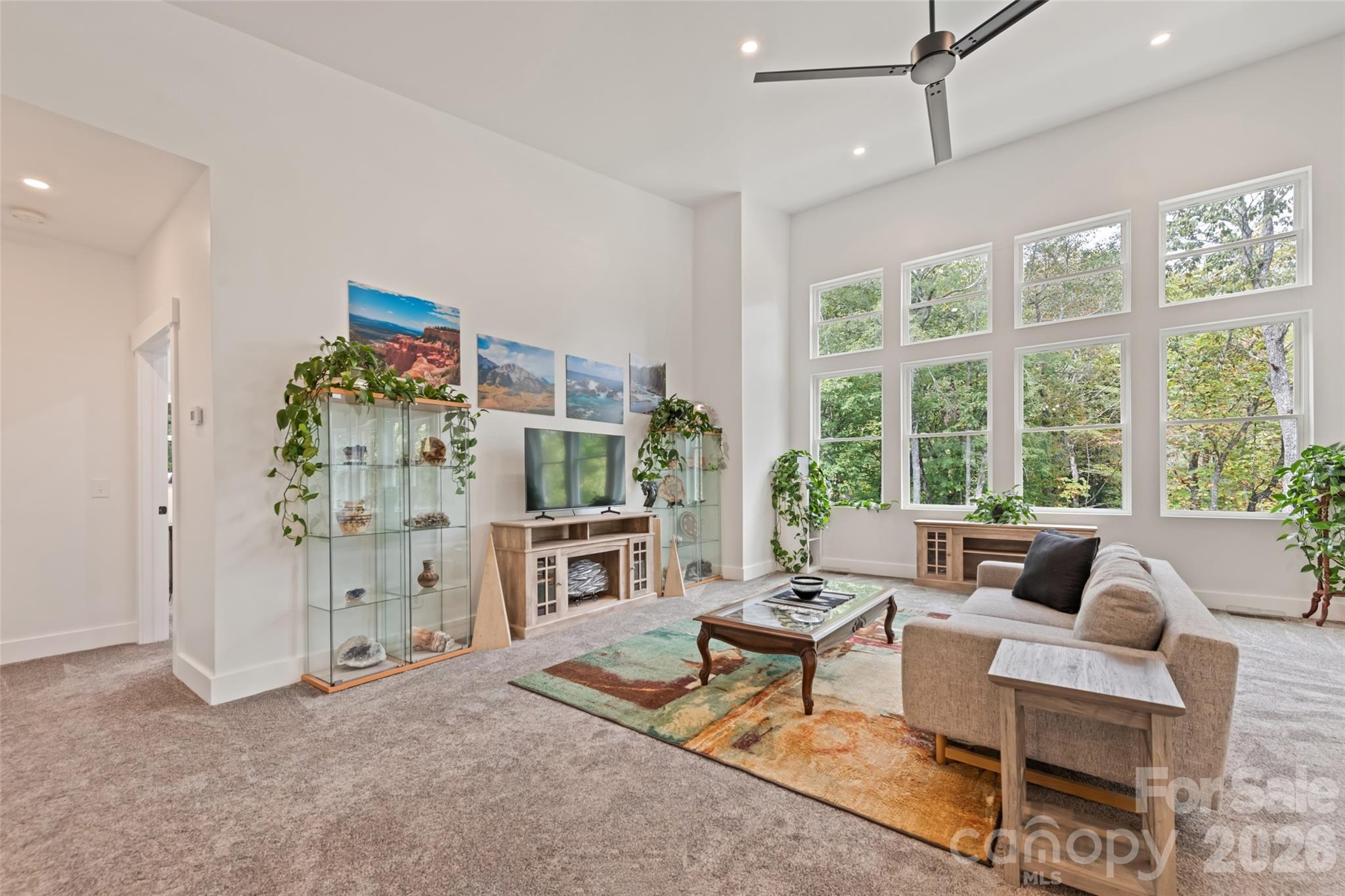 1185 Wallalieu Road Otto, NC 28763 - Photo 10 of 43 a living room with furniture and a floor to ceiling window