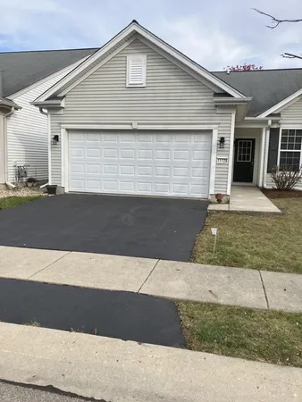a front view of a house with garage