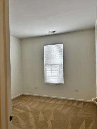 a view of an empty room and a window
