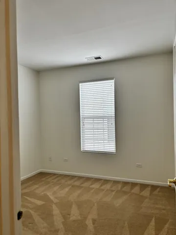 a view of an empty room and a window