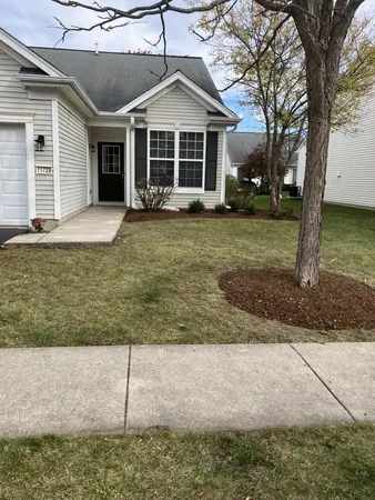 a large tree in front of a house