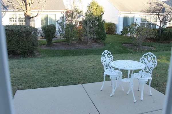 a view of backyard with outdoor seating and green space