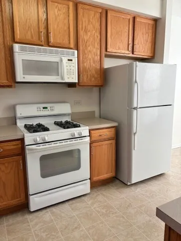 a kitchen with granite countertop white cabinets stainless steel appliances and sink