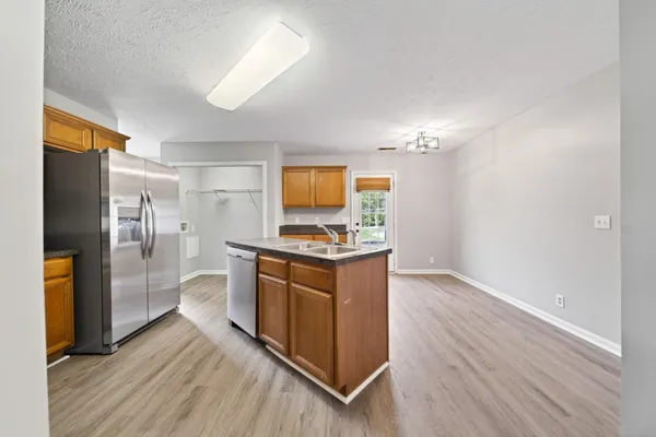 a view of a kitchen with a sink wooden floor and a window