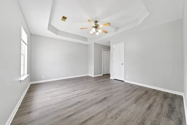 a view of entryway and hall with wooden floor