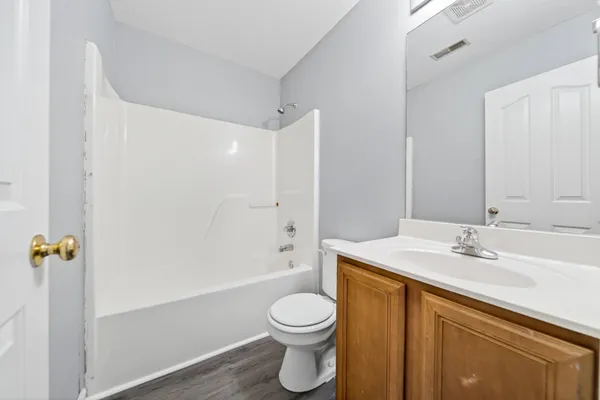a bathroom with a sink a toilet and a large mirror
