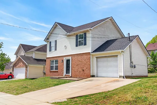 a kitchen with stainless steel appliances granite countertop a refrigerator a stove and a wooden floors