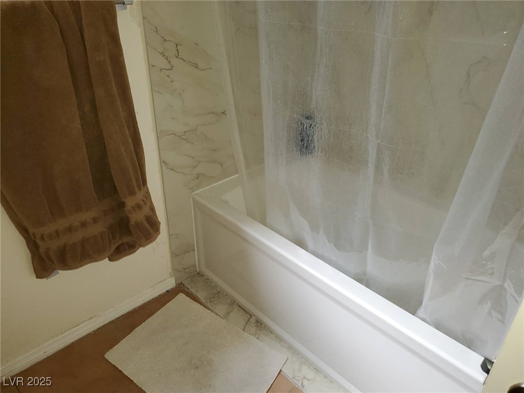 8070 West Russell Road, Unit 1005 Las Vegas, NV 89113 - Photo 7 of 12 Full bath with shower / bathtub combination with curtain and baseboards