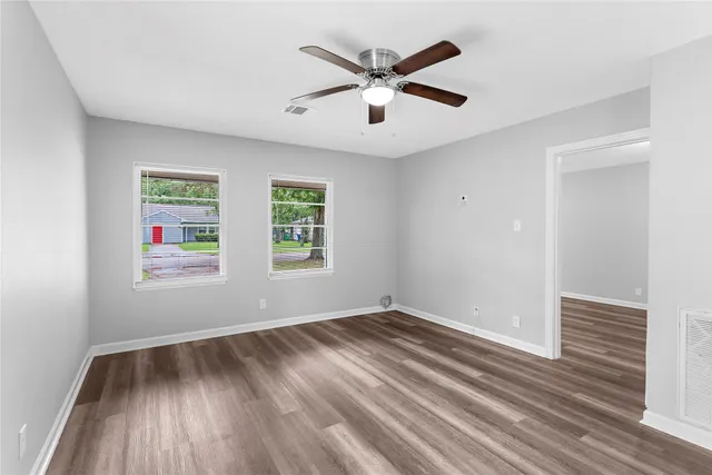 wooden floor in an empty room with a window