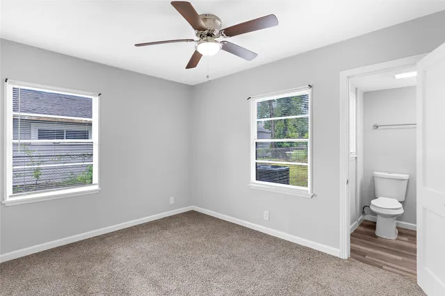 a view of empty room with ceiling fan
