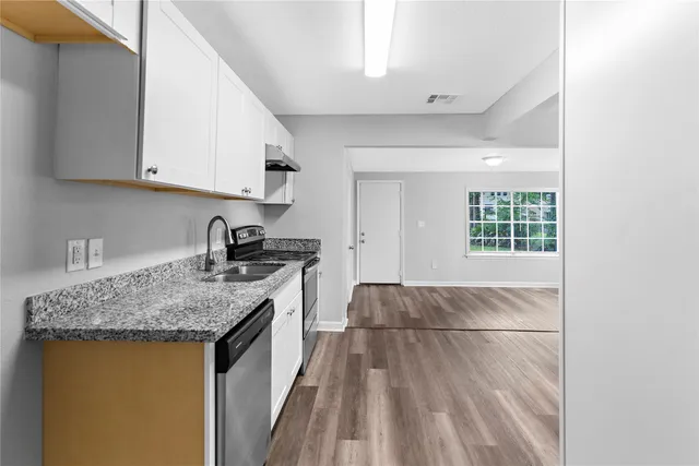 a kitchen with a sink stove and cabinets