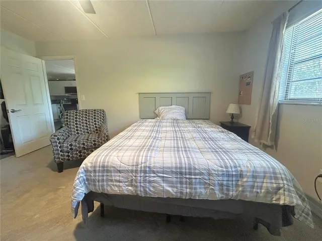 a bedroom with a bed and a chair