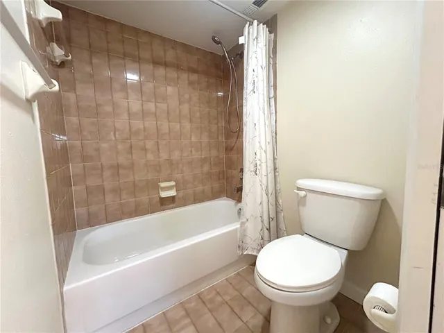 a bath room with a toilet and a bath tub
