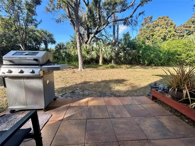 a view of a backyard with sitting area