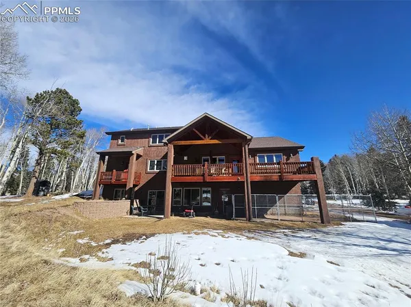 a view of a house with a yard covered in snow