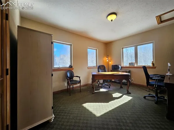 a living room with furniture pool table and a window