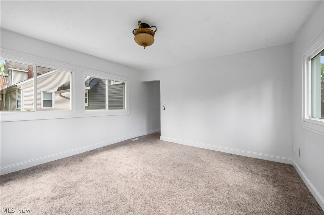 371 Merriman Road Akron, OH 44303 - Photo 18 of 27 Spacious interior room featuring light-colored carpeting, white painted walls, and white trim