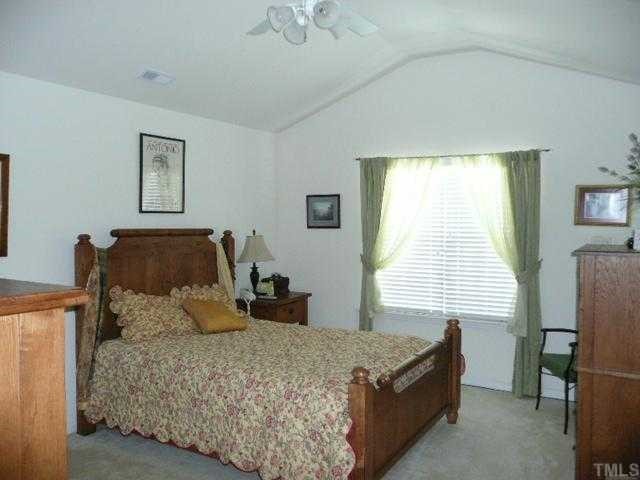 8510 Arboles Court Raleigh, NC 27613 - Photo 7 of 11 Large master bedroom with vaulted ceiling and fan. Nice walk in closet.