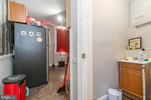 a bathroom with a sink vanity mirror and toilet