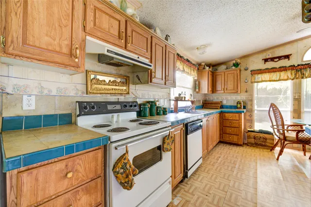 a kitchen with stainless steel appliances granite countertop a sink and cabinets
