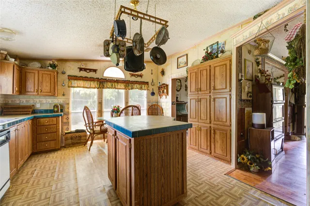 a kitchen with stainless steel appliances granite countertop a sink a stove and refrigerator
