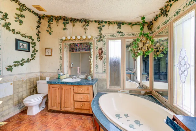 a bathroom with a granite countertop sink a toilet and bathtub