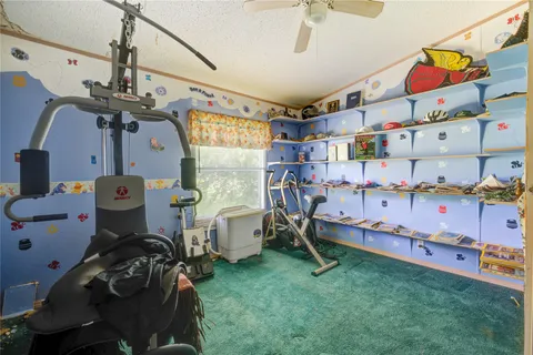 a bedroom with baby crib and a wooden floor