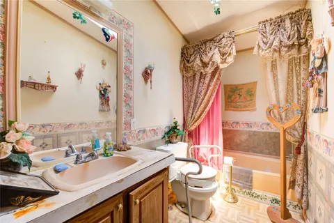 a bathroom with a sink vanity mirror and toilet