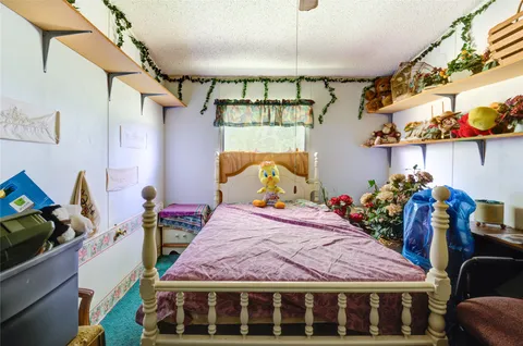 a bedroom with a bed a desk and chair