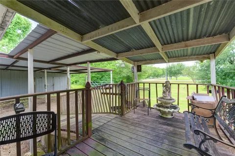 a view of balcony with wooden floor and outdoor seating
