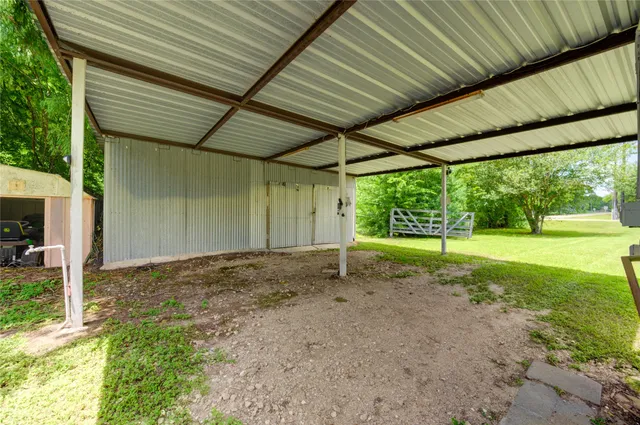 a view of a backyard with large trees