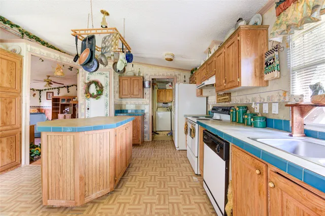a kitchen with stainless steel appliances granite countertop a stove and a sink