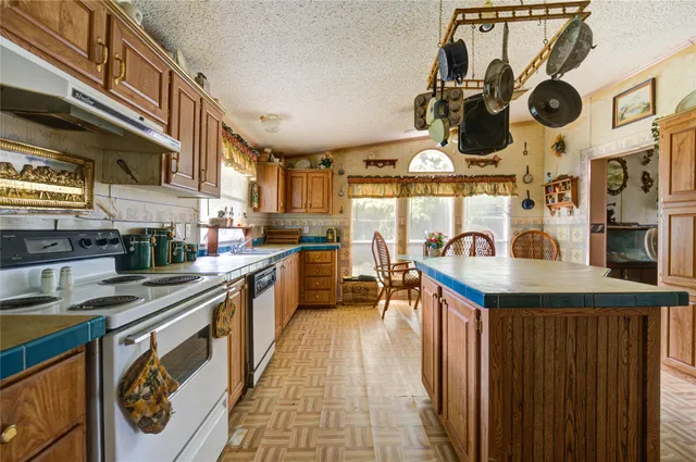 a kitchen with stainless steel appliances granite countertop a stove and a sink