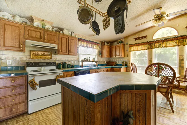 a kitchen with a cabinets a sink and appliances