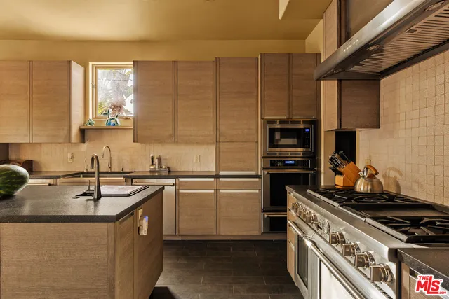 a kitchen with a sink stove and cabinets