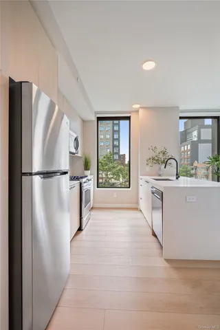 a kitchen with stainless steel appliances granite countertop a refrigerator and a sink