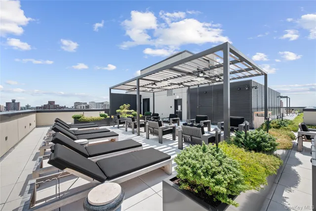 a view of a patio with couches table and chairs and potted plants