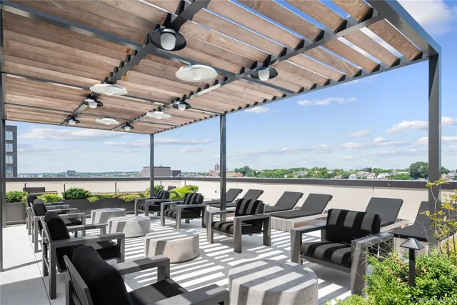 a outdoor space with furniture a rug and white walls