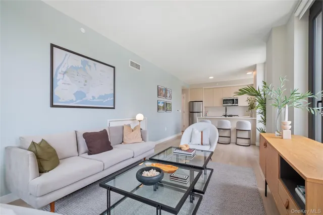 a living room with furniture and a painting on the wall