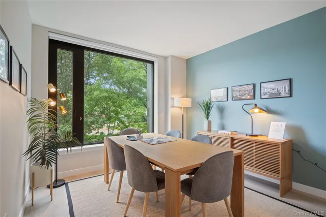 a view of a dining room with furniture window and wooden floor