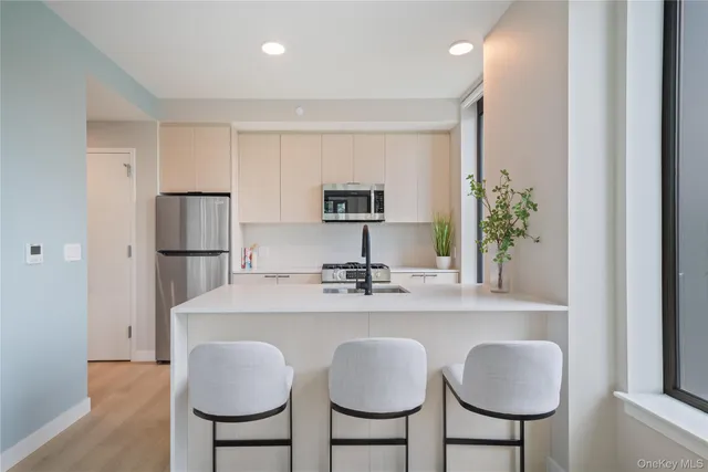 a kitchen with stainless steel appliances a sink and a refrigerator