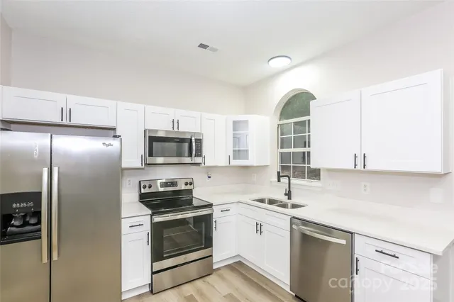 a kitchen with a refrigerator sink and microwave