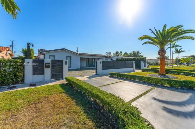 a view of a house with palm trees