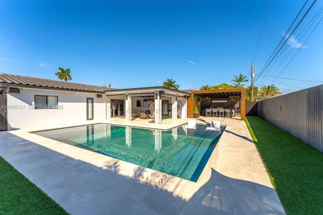 a view of house with patio furniture and garden