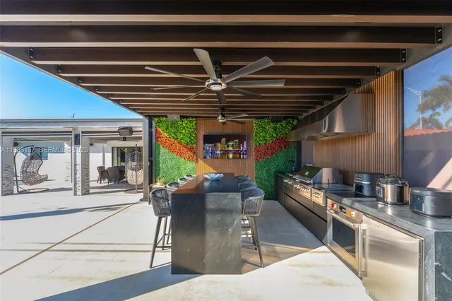 a view of a patio with table and chairs potted plants with floor to ceiling window and yard