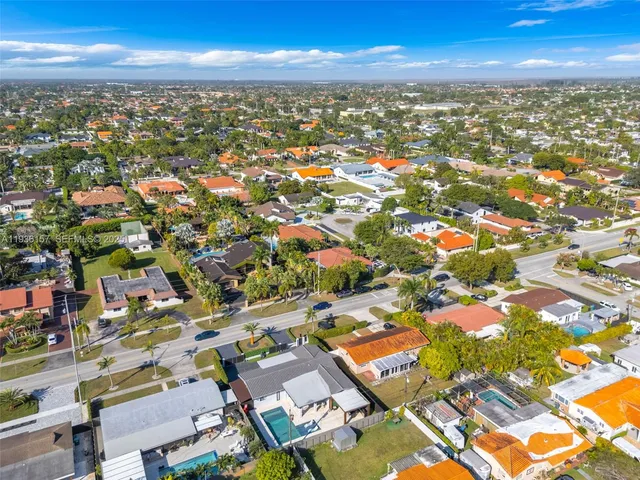 an aerial view of residential building with parking