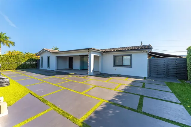 a house with swimming pool in front of it
