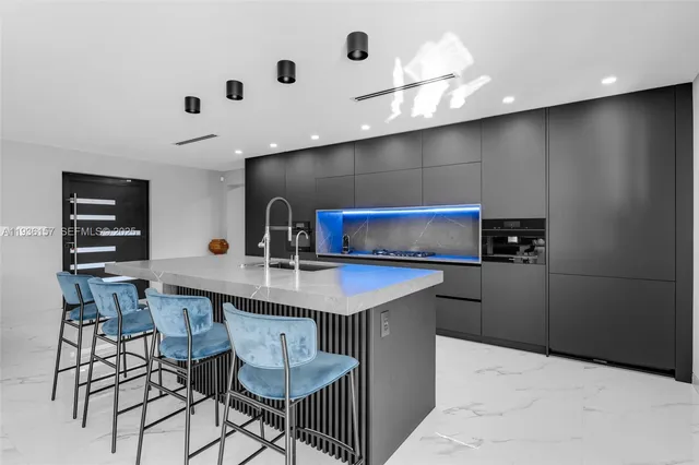 a kitchen with a table and chairs in it